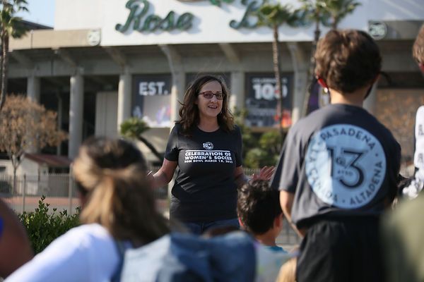 Speaker in a Celebration of Women's Soccer t-shirt addressing players outside the Rose Bowl