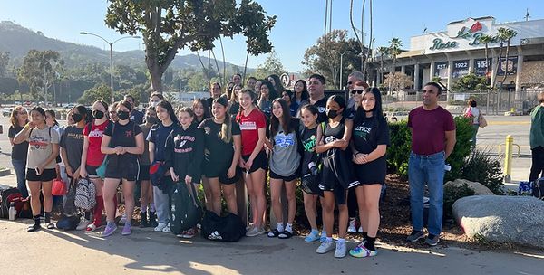 Group of Region 13 players and coaches posing in front of the Rose Bowl entrance