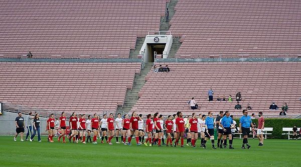 Two teams walking onto the Rose Bowl pitch in line before the exhibition match